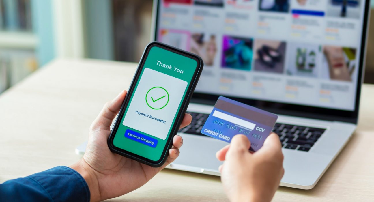 hands-using-phone-credit-card-online-payment-1296x700.jpg